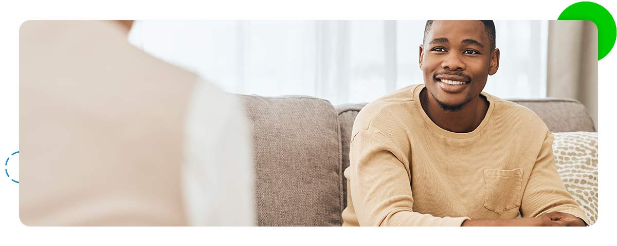 Happy mental health patient talking to therapist